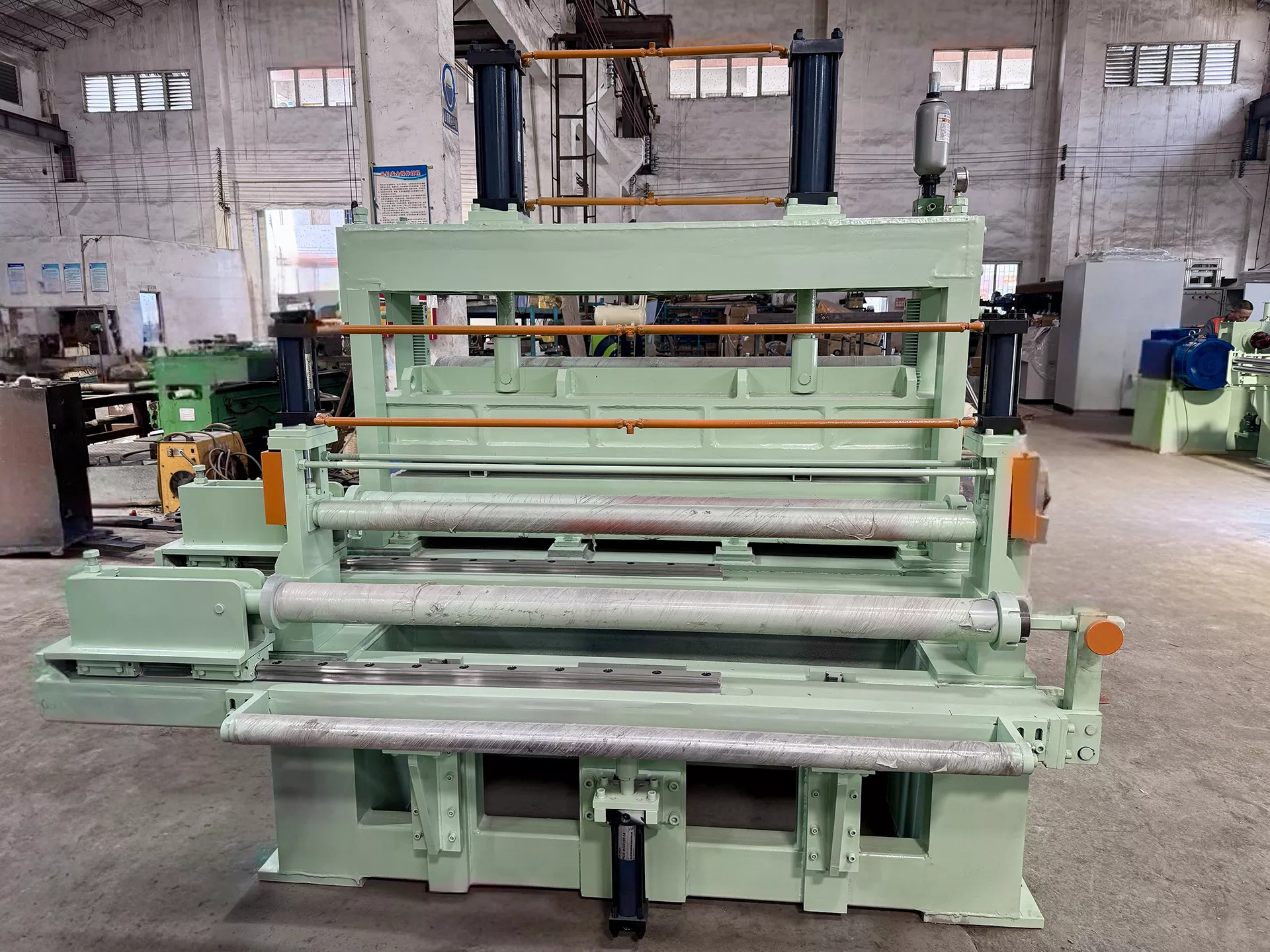 The tension station controls coil tension, prevents wrinkles/misalignment, and ensures smooth slitting.