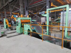 Cut large galvanized steel coils into precise narrow strips for industrial use.