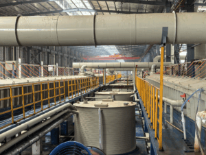 A pickling line removes scale and rust from metal surfaces for further processing. Steps include uncoiling, pickling, rinsing, drying, and recoiling.